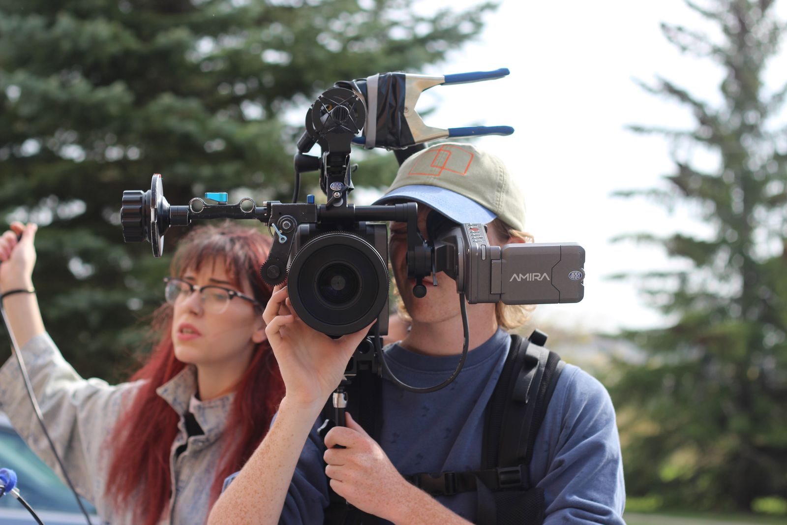 Dois cineastas operam uma câmera Arri Amira em um ambiente natural ao ar livre