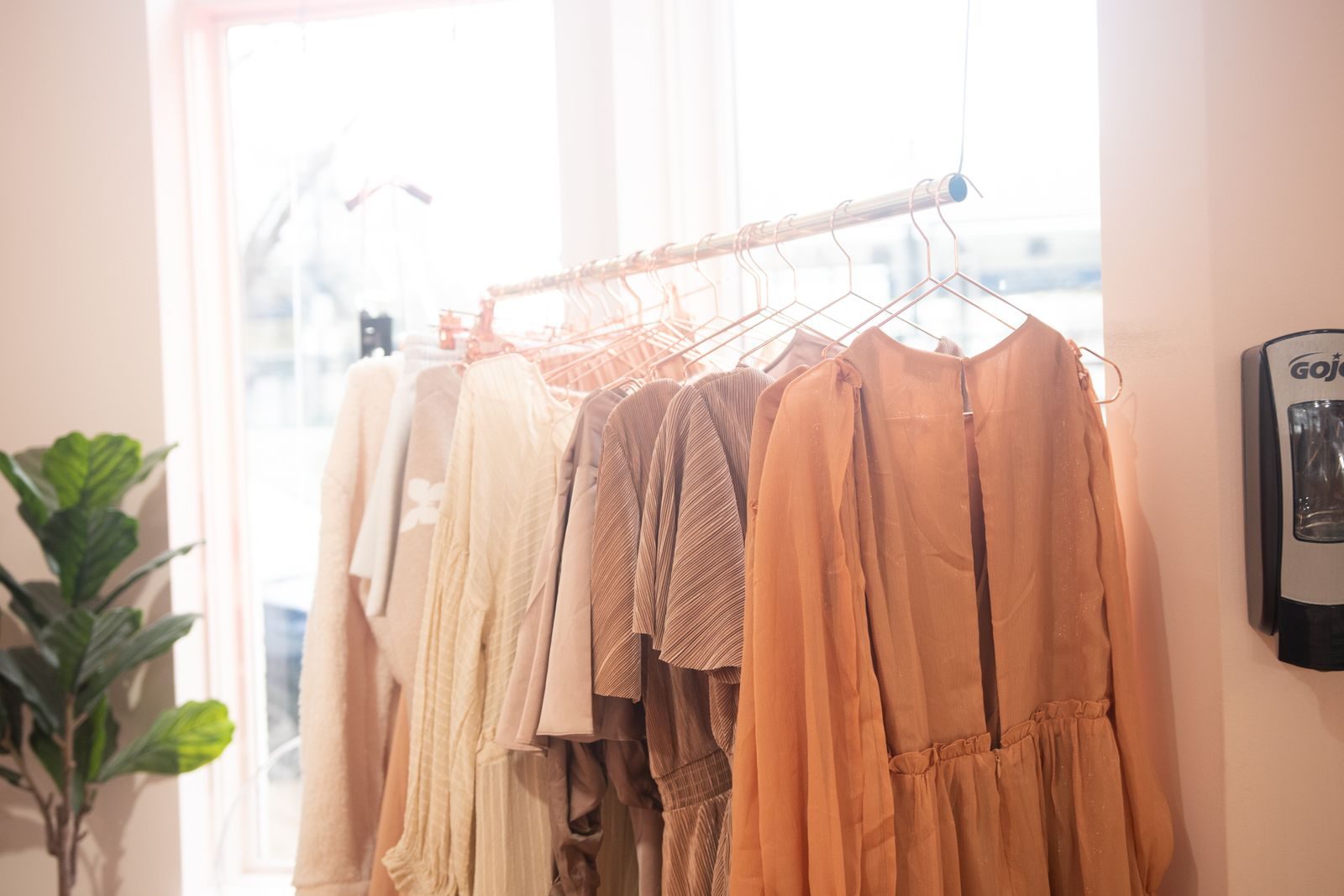 Coleção de vestidos elegantes em cabides em uma boutique iluminada