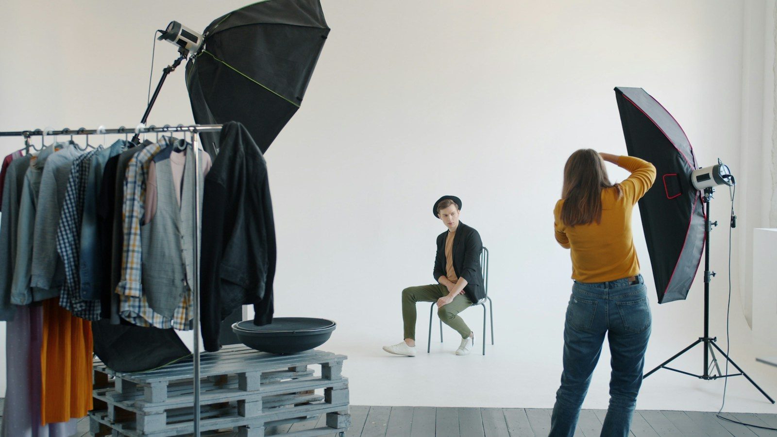 Fotógrafo orientando modelo em ensaio fotográfico no estúdio
