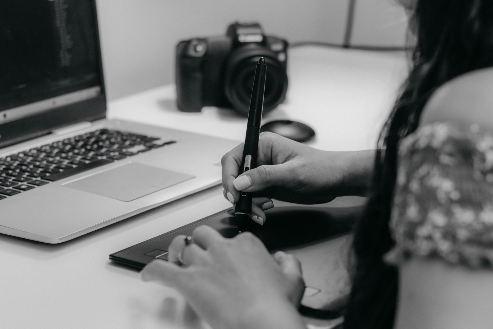 Designer trabalhando com mesa digitalizadora e notebook