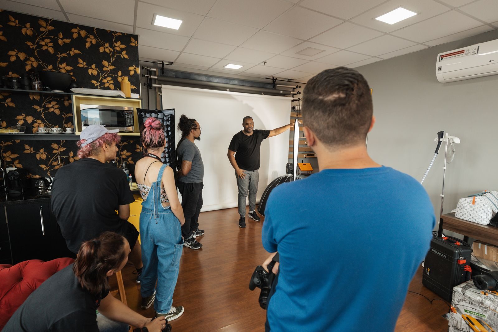 Grupo de fotógrafos e modelos trabalhando juntos em estúdio moderno
