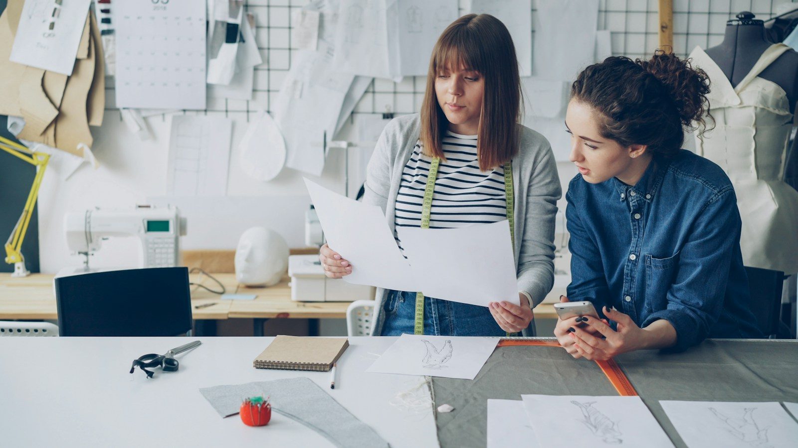 Duas mulheres discutem projetos de design em uma oficina